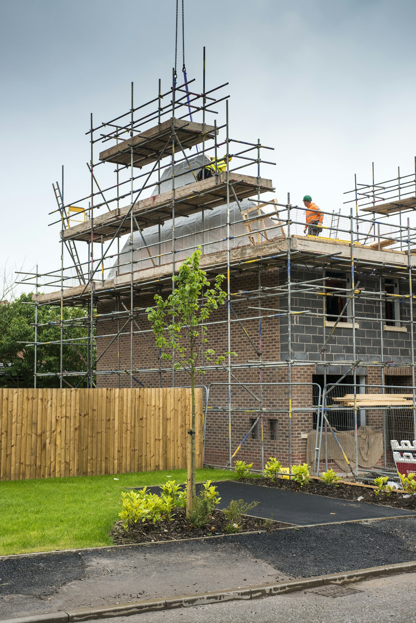 Construction worker on roof of building site