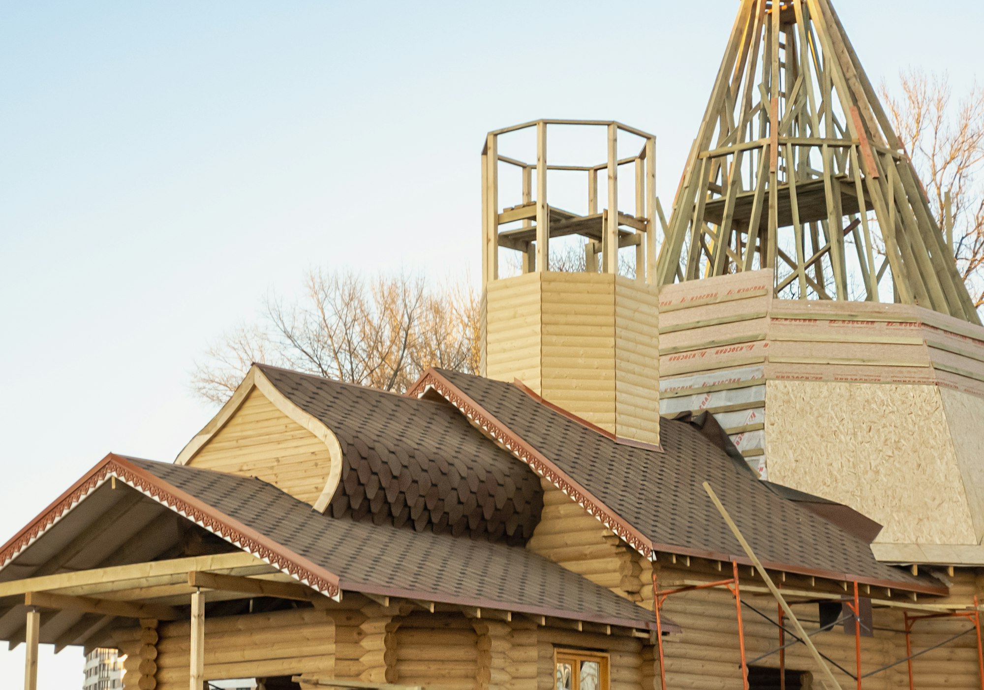 Minsk, Belarus-March 2022: Construction of a wooden chapel. Erection of the roof and dome